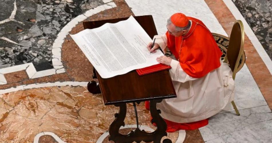 Cardinal Kevin Farrell signs the Rogito